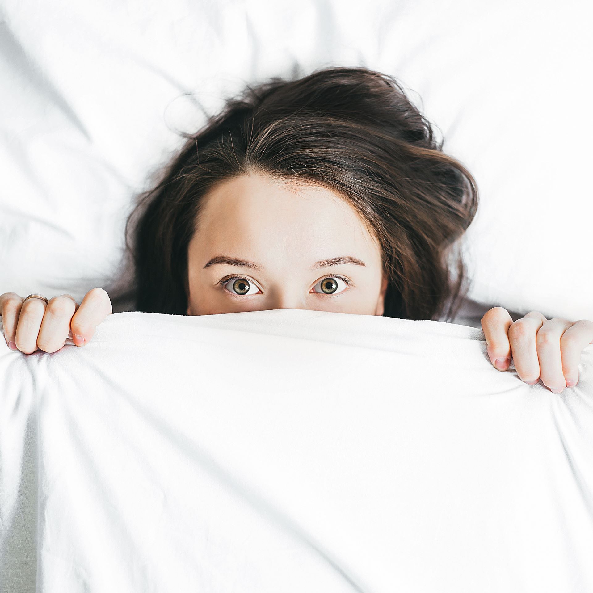 a person taking a selfie in bed